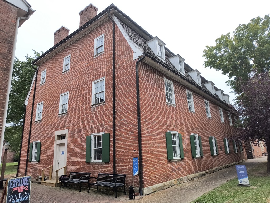 Red Brick, three story building with sloping upper floor