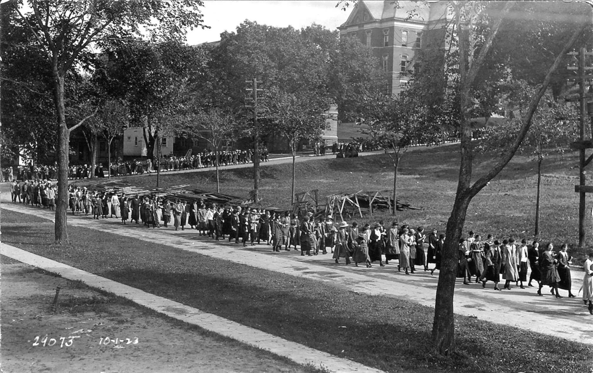 Convocation parade in 1923 walking along Madison Street on the west side of the Pentacrest.
